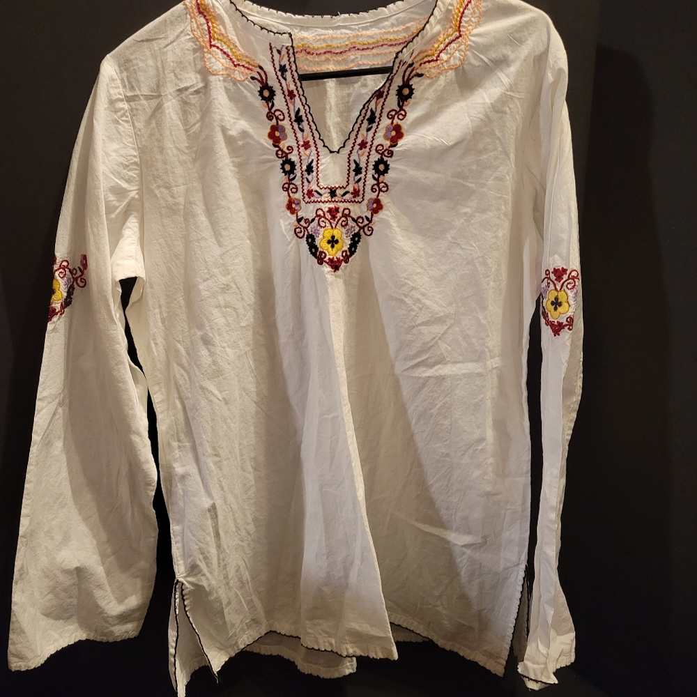 White embroidered long sleeved top. No tags on it but very well made.